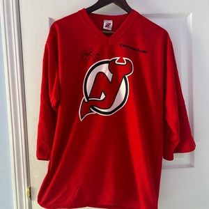 New jersey Devils shirt. Signed by Bruce Driver of the New Jersey Devils